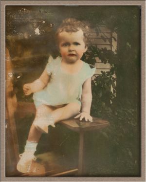 Before Moderate Digital Photo Restoration of Hand-Colored Outdoor Baby Portrait
